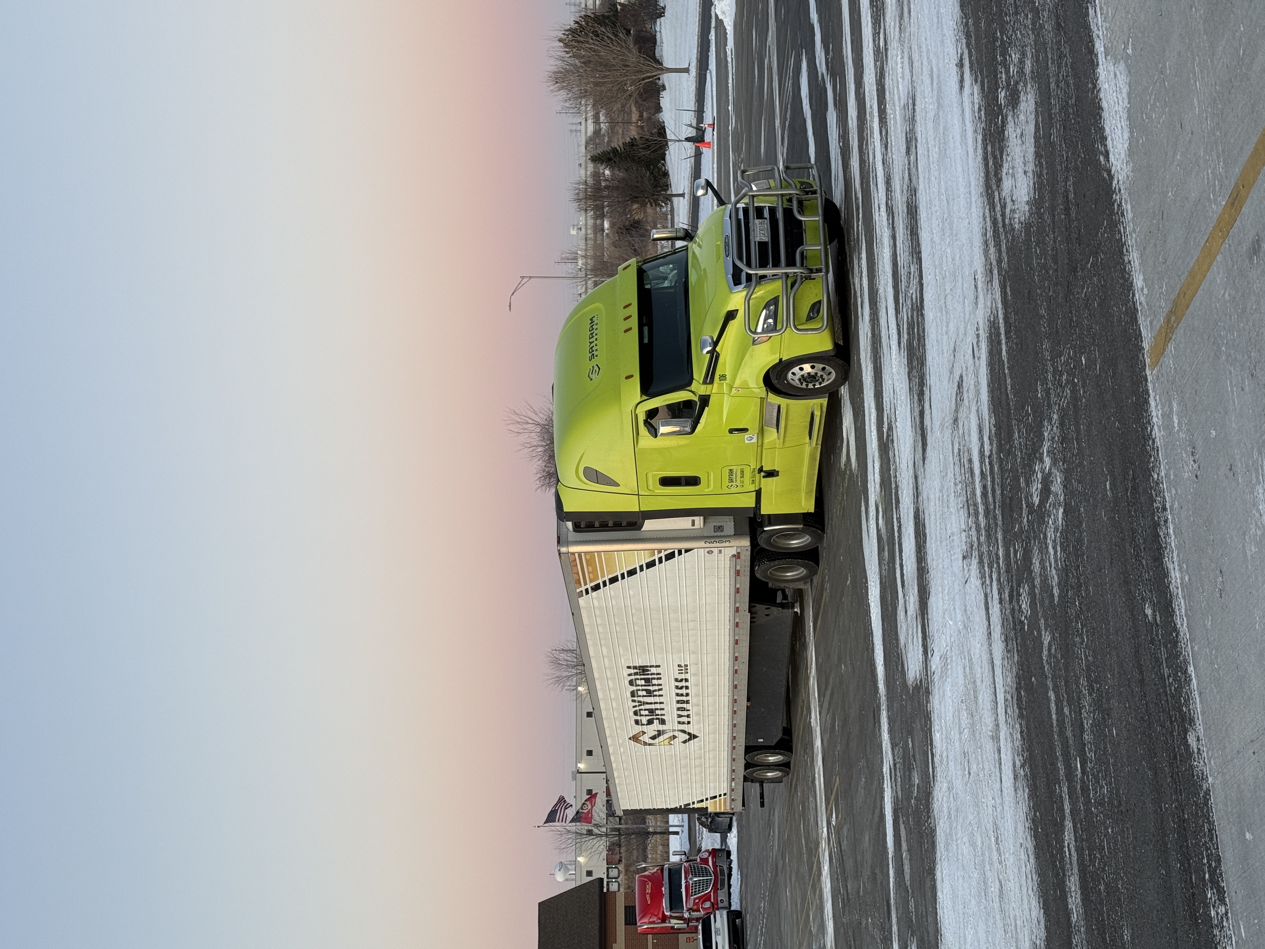 Sayram Express truck on highway at sunset